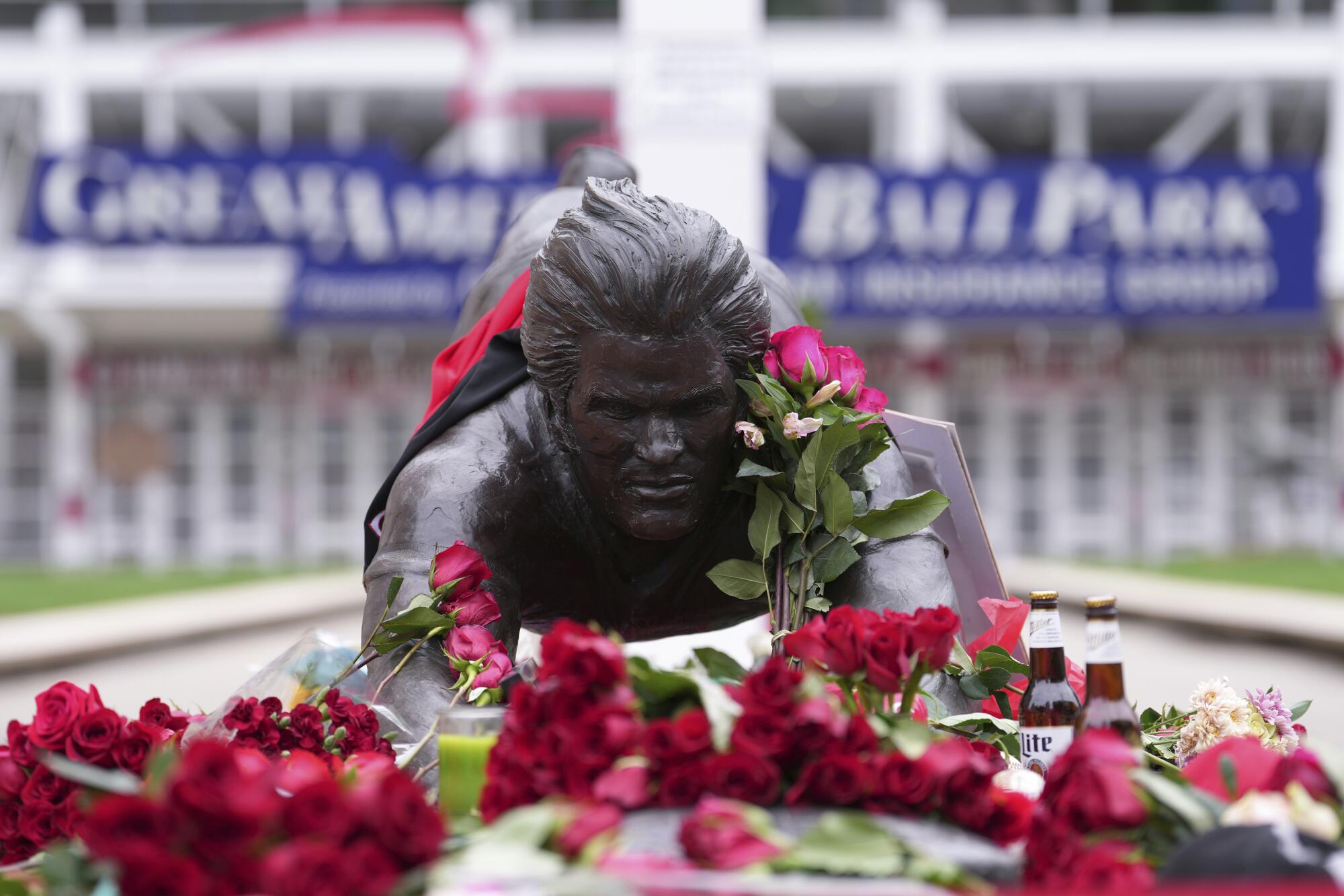 Roses adorn the statue of Pete Rose at Great American Ballpark in Cincinnati after the all-time hits leader died.