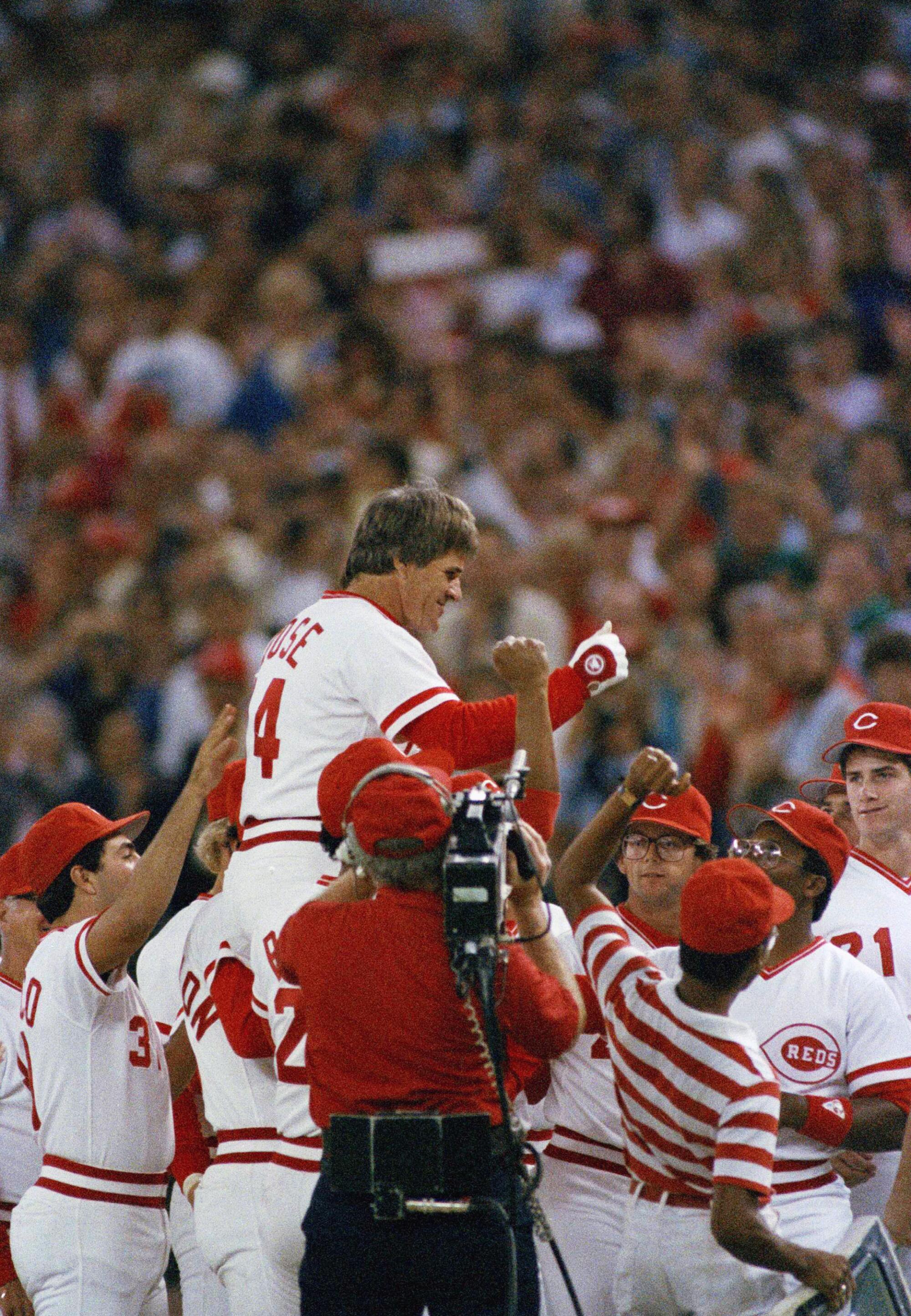 Cincinnati Reds player-manager Pete Rose is congratulated by his teammates after he broke Ty Cobb's hitting record.