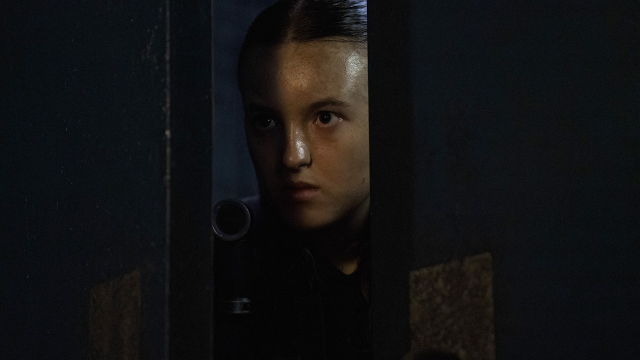 Ellie peeking through a slightly open door in The Last of Us season 2 finale