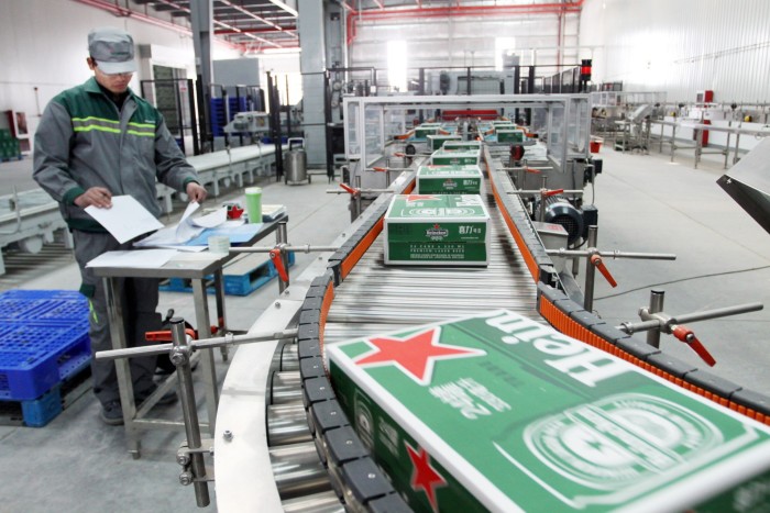 The boxes are moving along a conveyor belt