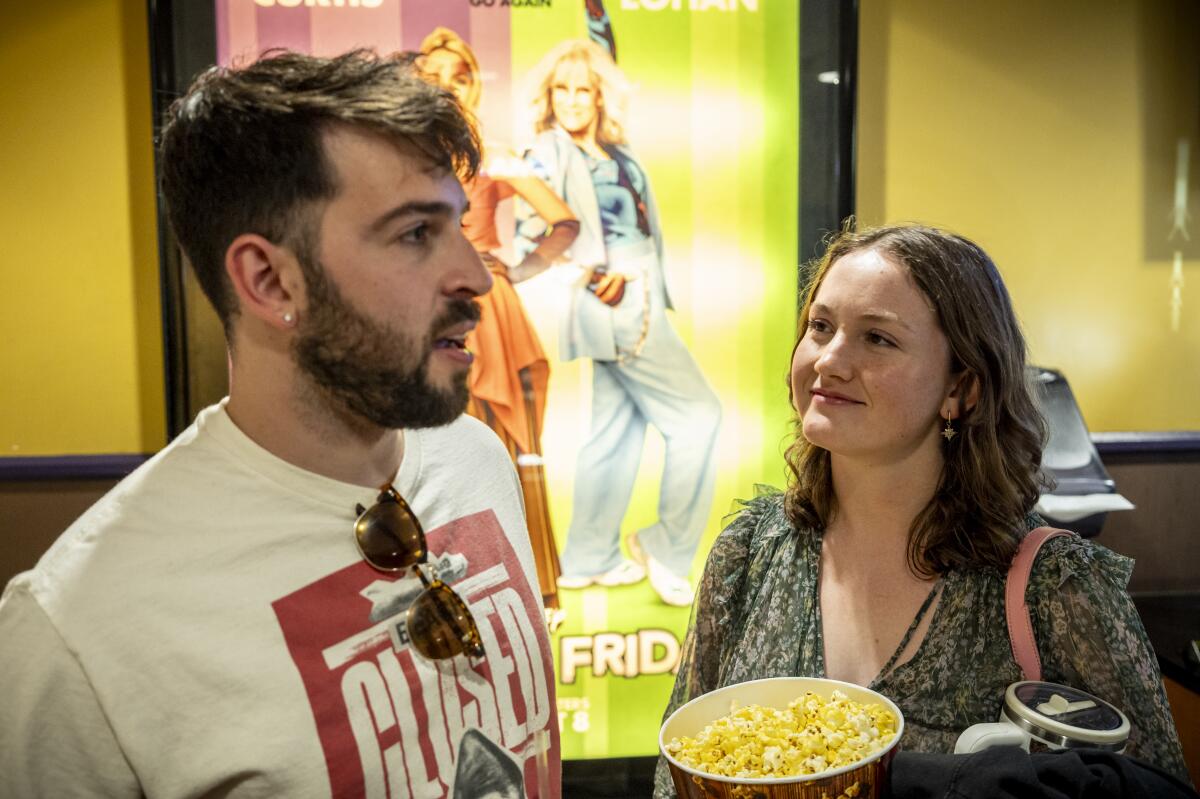 A photo of a man and a woman at a movie theater