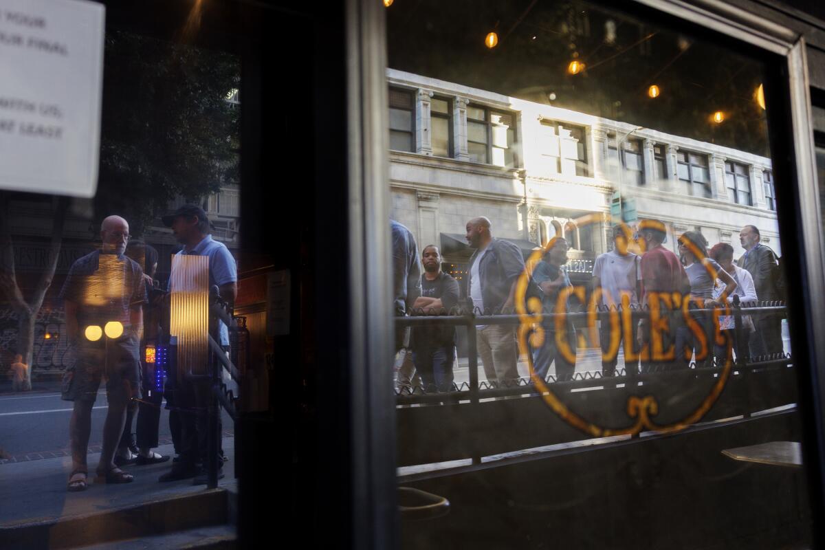 Reflected in the restaurant windows, locals flock to Cole's French Dip.