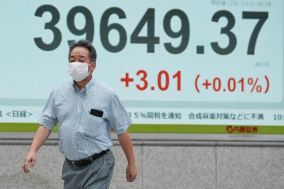 Asian shares are mixed after Wall Street closes higher and edges to more records