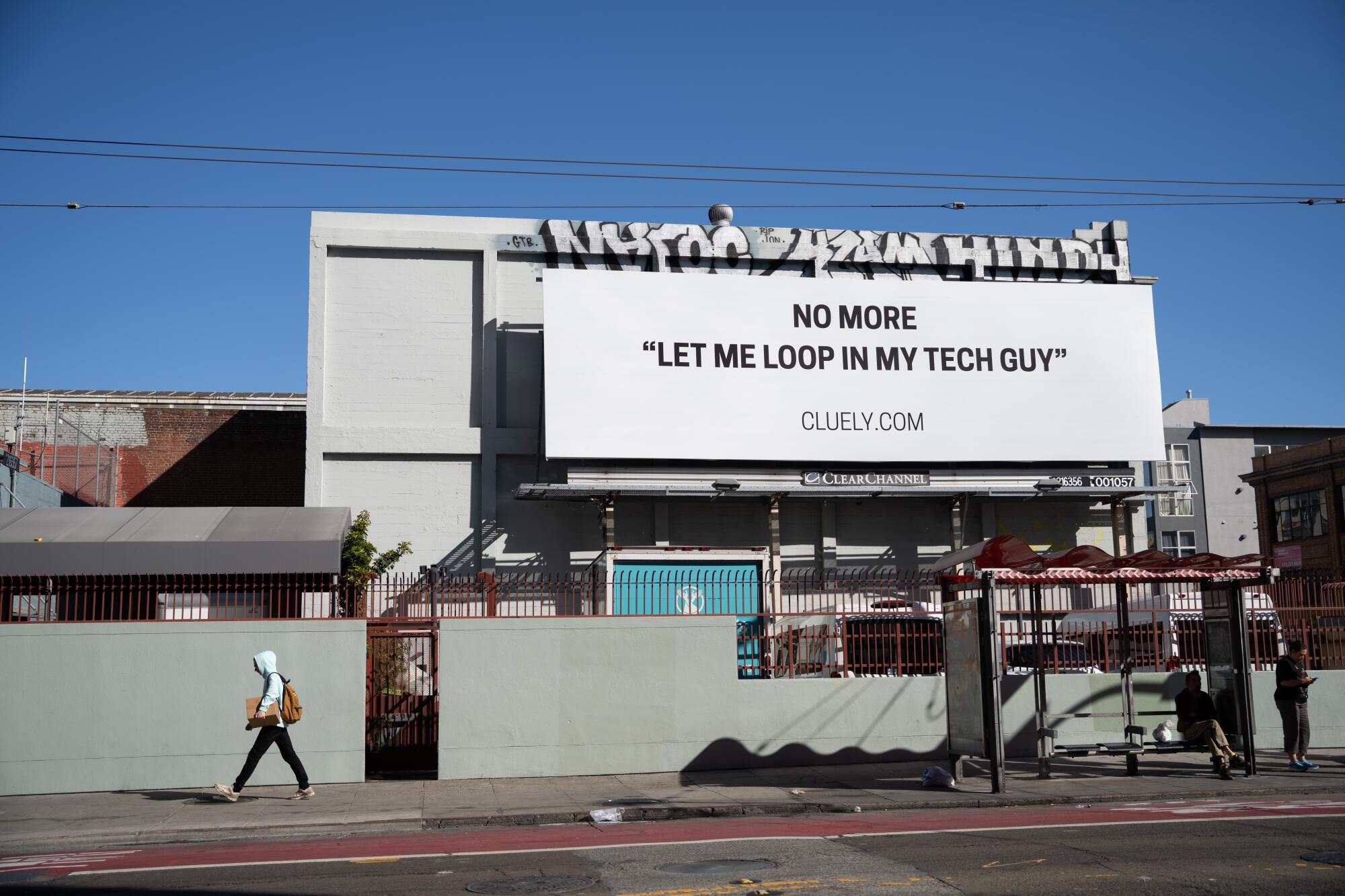 A billboard advertising Cluely, an AI company, rises over Mission Street in downtown San Francisco.