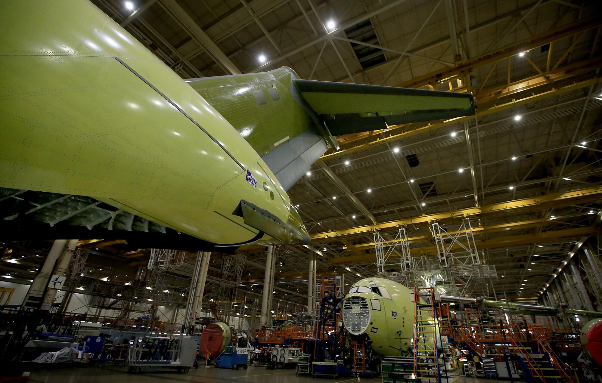 Boeing C-17 military transport planes in various stages of completion at the company's facility in Long Beach.