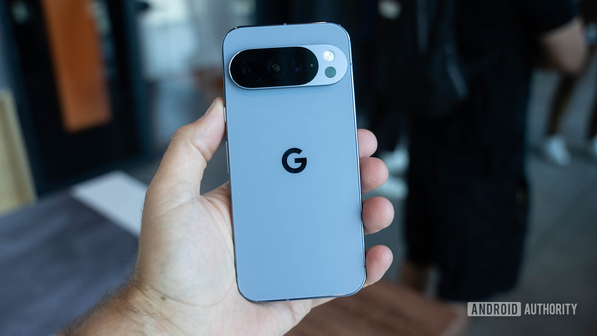 Google Pixel 10 Pro in Moonstone in a man's hands showing back Google Pixel 10 Pro in Moonstone in a man's hands showing back