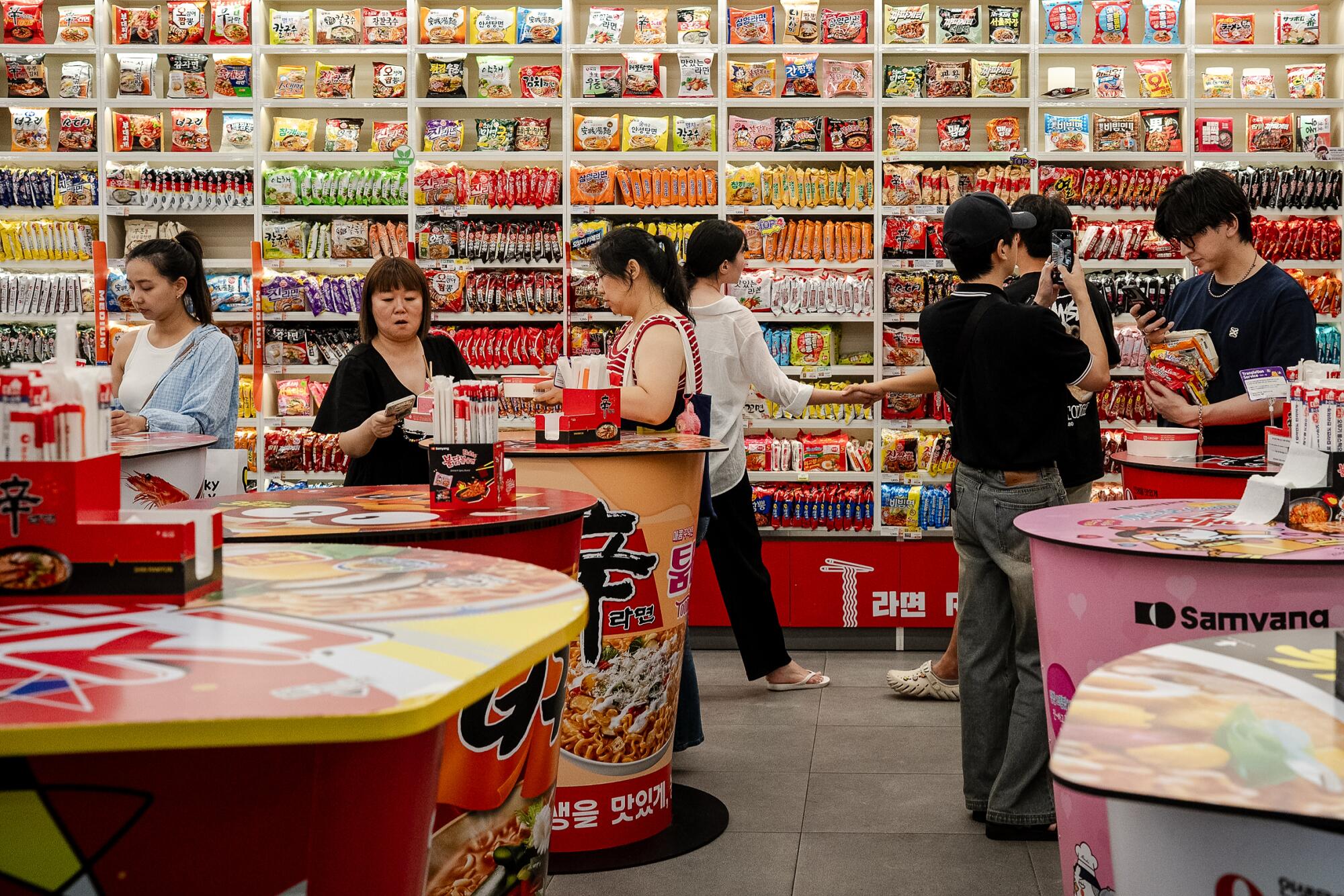 People shop and eat in the dining area at a CU convenience store in Seoul.