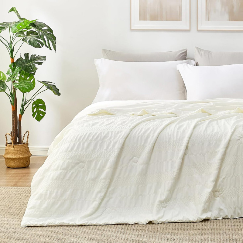 Amazon is selling a 'buttery-soft' $109 reversible cooling queen comforter that feels 'light and airy' for only $55