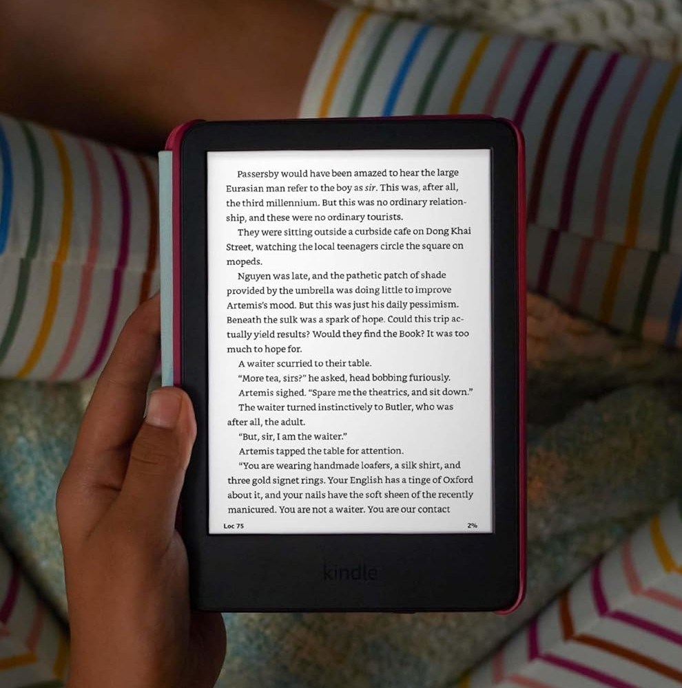 A person holding the kid-friendly Kindle in their lap.